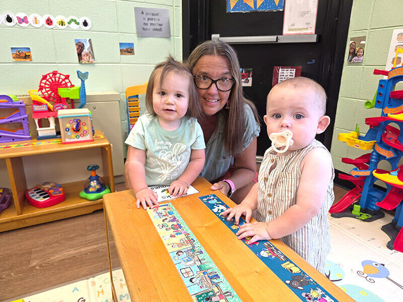 Roberta Ballew interacts with two toddlers in the McDowell Tech Child Development Center